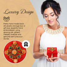 Load image into Gallery viewer, Model holding red silk square keepsake box with gemstones. 
