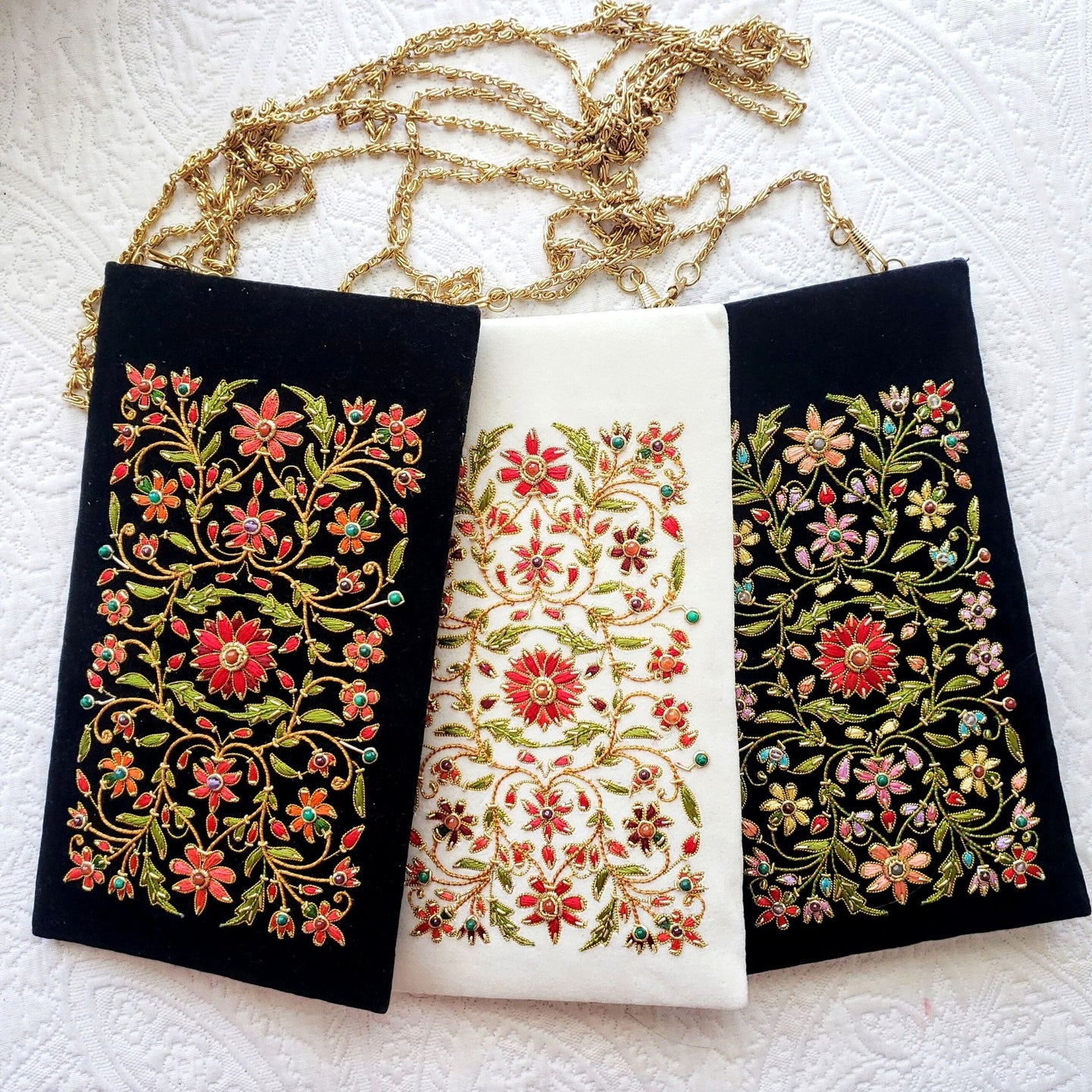 Three hand embroidered floral eyeglasses sunglasses cases on black or ivory velvet with chain. 