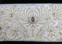 Load image into Gallery viewer, Luxury silver embroidered floral slim clutch on pale blue silk and embellished with amethyst gemstones, zardozi work, close up view. 
