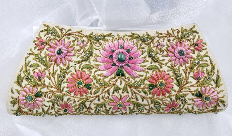 Luxury hand embroidered pink floral silk clutch bag on light gold silk, embellished with emeralds, zardozi handbag, side view.