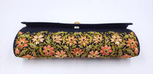 Load image into Gallery viewer, Formal black silk evening clutch bag embroidered with orange flowers all over and embellished with rubies, bottom view.
