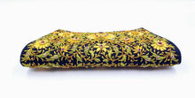 Load image into Gallery viewer, Black clutch embroidered with yellow flowers and embellished with rubies, bottom view. 
