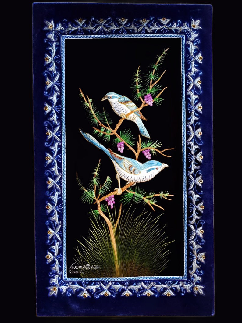 Embroidery wall art of two blue birds embroidered in silk on blue velvet with ornate border, zardozi art.