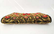 Load image into Gallery viewer, Designer black silk clutch bag with embroidered red flowers and rubies on both sides, bottom view. 
