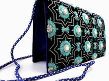 Load image into Gallery viewer, Navy blue velvet clutch bag embroidered with silver and teal art deco inspired design and embellished with semi precious stones, zardozi evening bag, cord strap, side view. 
