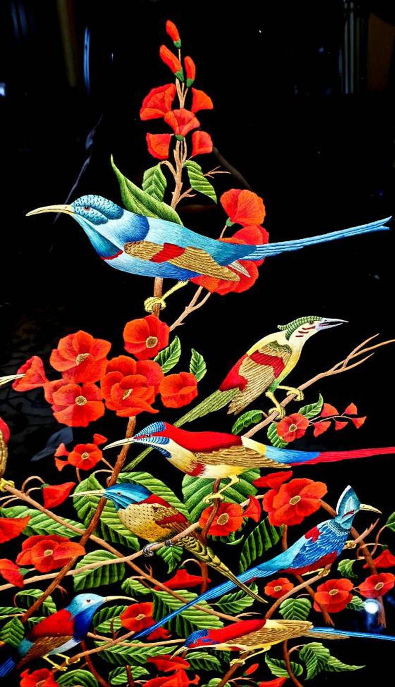 Birds of Paradise hand embroidered silk tapestry of eight colorful birds in a red flower bush, close up view. 