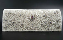 Load image into Gallery viewer, Bridal clutch in ivory velvet embroidered with silver lotus flowers and embellished with amethyst, zardozi evening bag.
