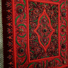 Load image into Gallery viewer, Hand embroidered Jewel carpet wall hanging, red flowers embroidered on burgundy red velvet, inlaid with agate stones, zardozi tapestry, side view.
