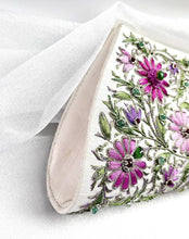 Load image into Gallery viewer, Lavender purple and pink lotus flower embroidered on white silk clutch and embellished with emeralds and rubies, zardozi handbag, side view. 
