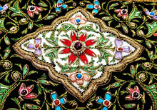 Load image into Gallery viewer, Small silk embroidered floral tapestry, multicolor silk flowers embroidered on black velvet in a carpet pattern, zardozi carpet tapestry, close up view.

