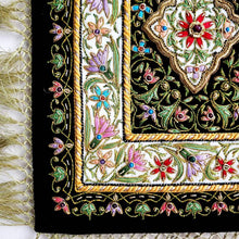 Load image into Gallery viewer, Small silk embroidered floral tapestry, multicolor silk flowers embroidered on black velvet in a carpet pattern, zardozi carpet tapestry, view of border.
