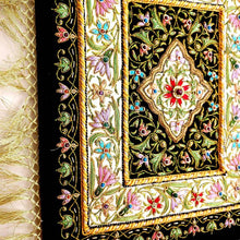 Load image into Gallery viewer, Small silk embroidered floral tapestry, multicolor silk flowers embroidered on black velvet in a carpet pattern, zardozi carpet tapestry, side view. 
